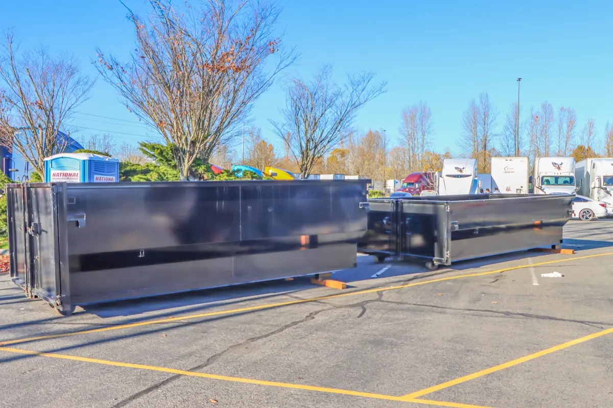 Professional dumpster rental service with roll-off container on residential driveway in Melbourne